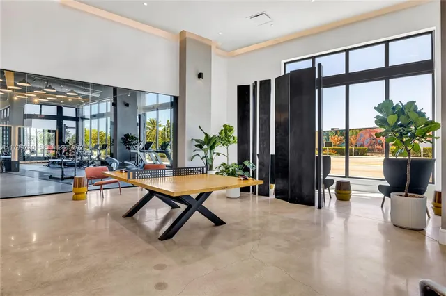 a view of a livingroom with furniture and floor to ceiling window