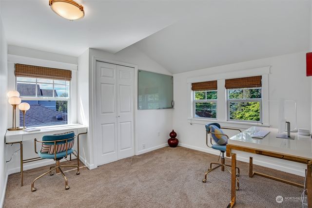a view of a workspace with a window and lounge chair