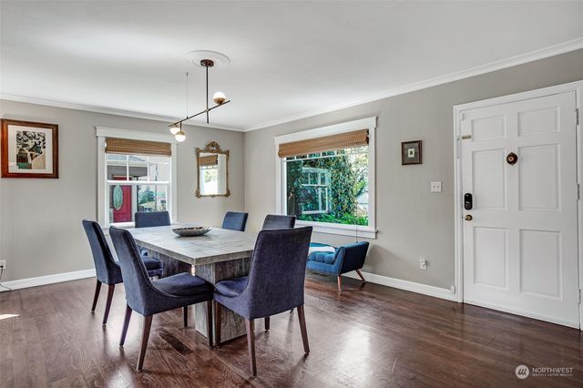 a view of a dining room with furniture window and wooden floor