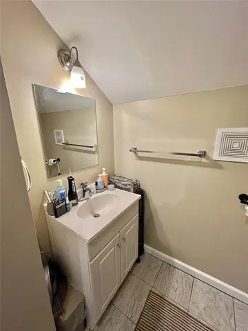 a bathroom with a sink a toilet and mirror