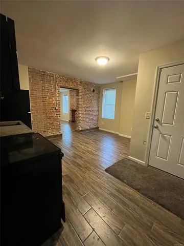 a living room with a couch and a stove next to a window