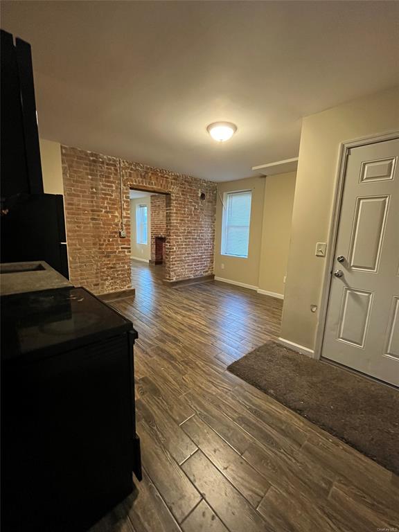 9 Clinton Street Poughkeepsie, NY 12601 - Photo 32 of 46 a living room with a couch and a stove next to a window