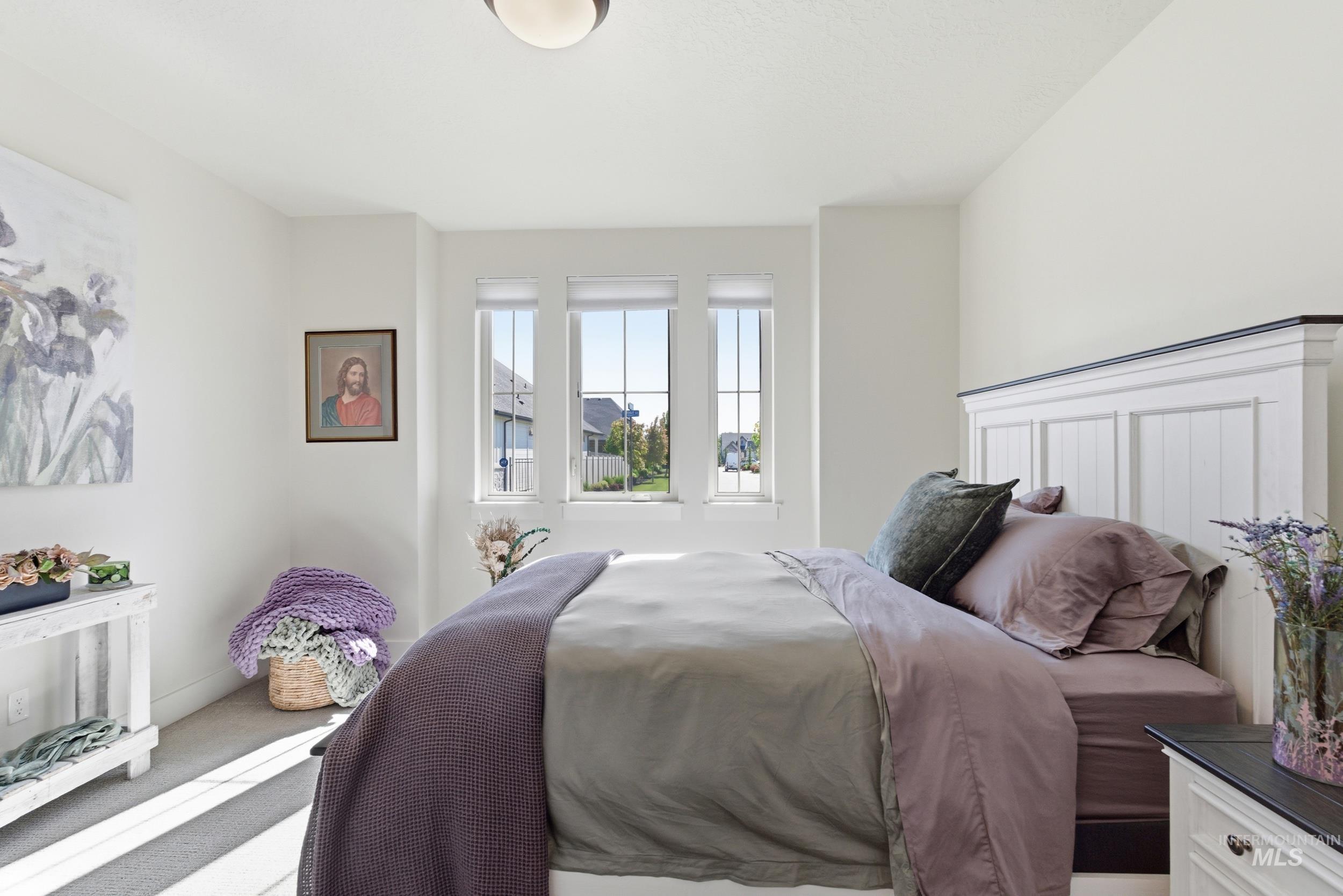 6347 South Utmost Lane Meridian, ID 83642 - Photo 16 of 37 Bedroom featuring a white paneled headboard, carpeted flooring, and three vertical windows with white blinds