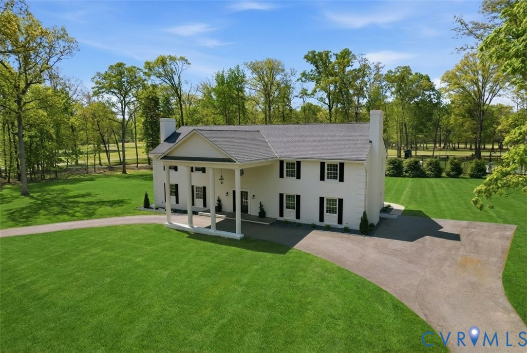 a view of a house with a yard porch and sitting area