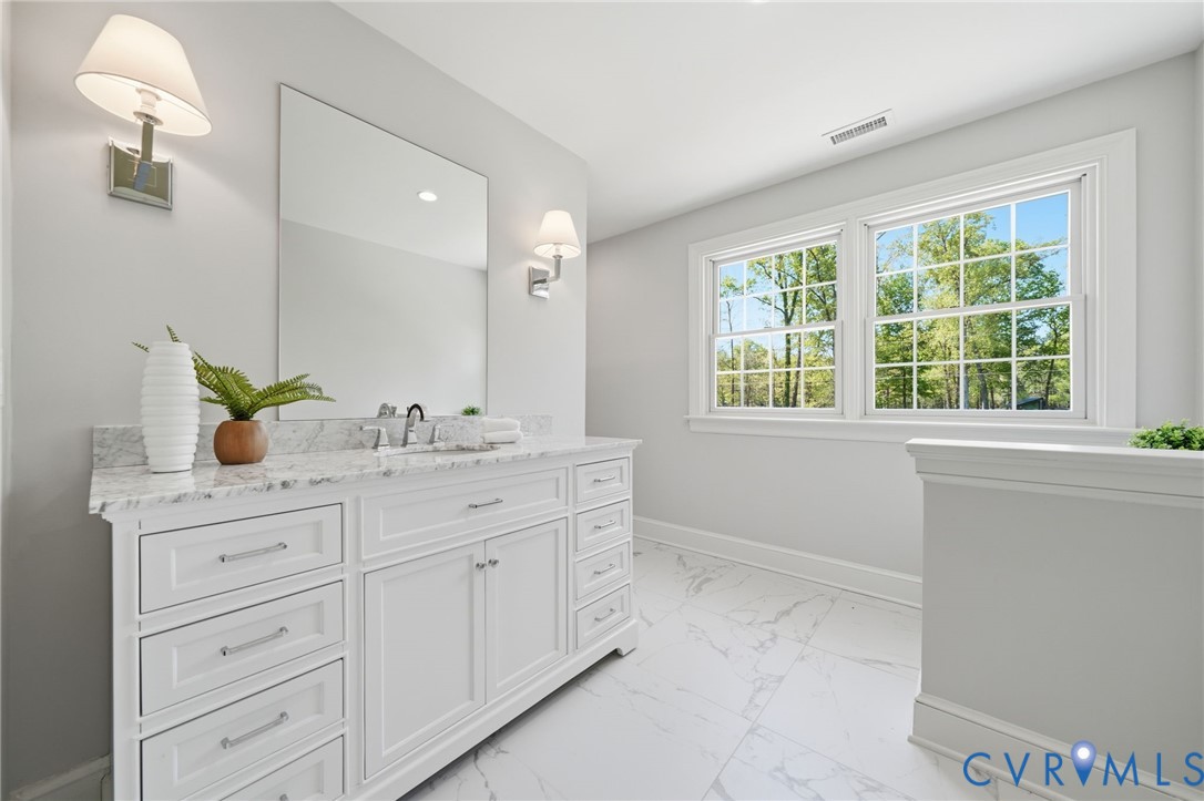 2540 Kentford Road Midlothian, VA 23113 - Photo 38 of 47 a spacious bathroom with a granite countertop sink mirror and window