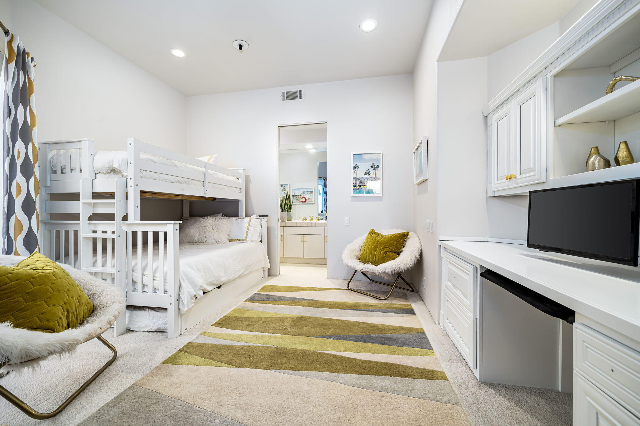 75720 Vista Del Rey Indian Wells, CA 92210 - Photo 18 of 31 a spacious bedroom with a bed a couch and a flat tv screen on the table