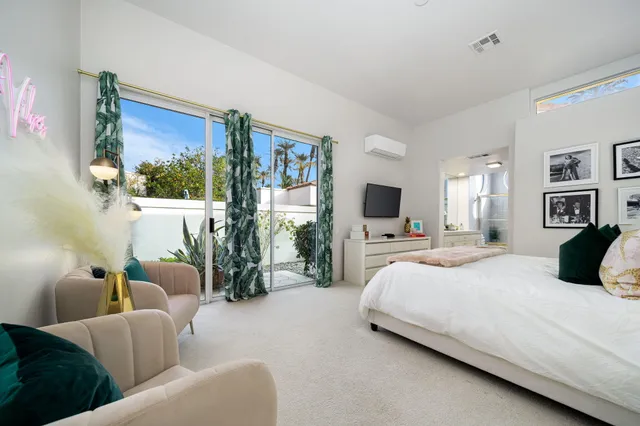 a bedroom with a bed and a flat tv screen