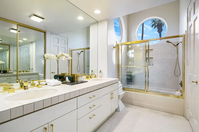 a bathroom with a double vanity sink mirror double and shower