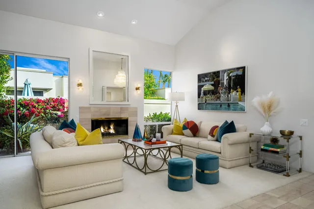 a living room with furniture potted plant and a fireplace