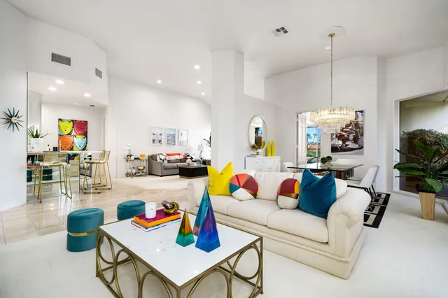 a living room with furniture and kitchen view
