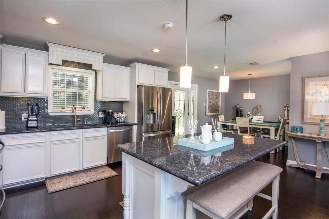150 Edgewater Way Point Blank, TX 77364 - Photo 1 of 48 a kitchen with granite countertop kitchen island stainless steel appliances a stove center island a sink cabinets and a counter top space