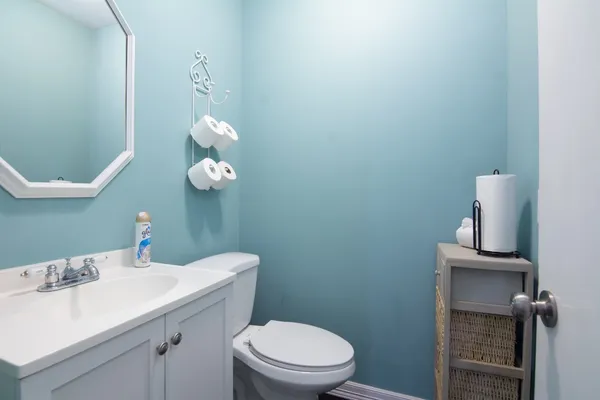 a bathroom with a sink a toilet and a mirror