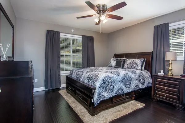 a bedroom with a bed and wooden floor
