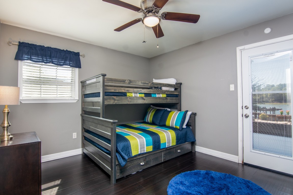 150 Edgewater Way Point Blank, TX 77364 - Photo 14 of 48 a bedroom with a bed and a chandelier