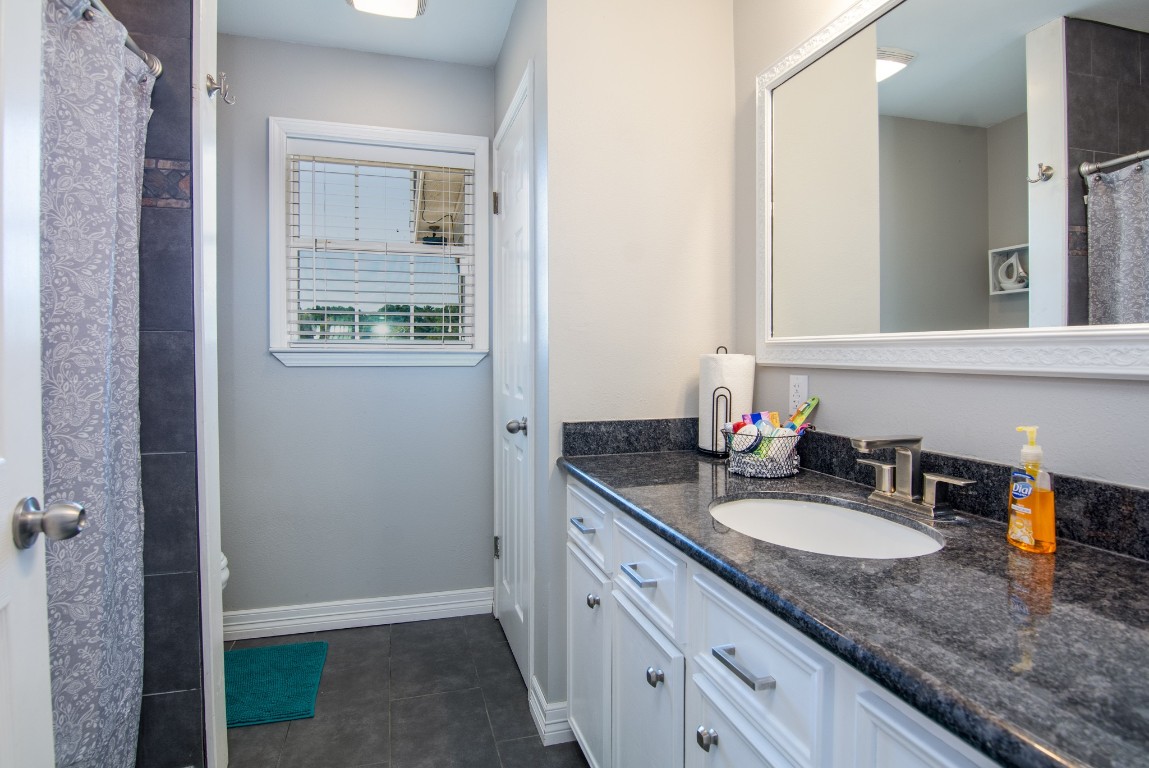 150 Edgewater Way Point Blank, TX 77364 - Photo 15 of 48 a bathroom with a granite countertop sink and a mirror