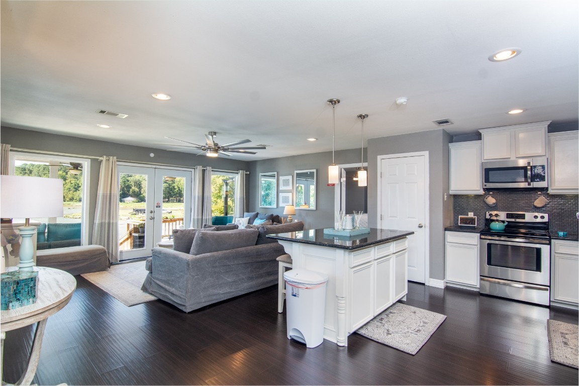 150 Edgewater Way Point Blank, TX 77364 - Photo 2 of 48 a living room with stainless steel appliances granite countertop furniture and a wooden floor
