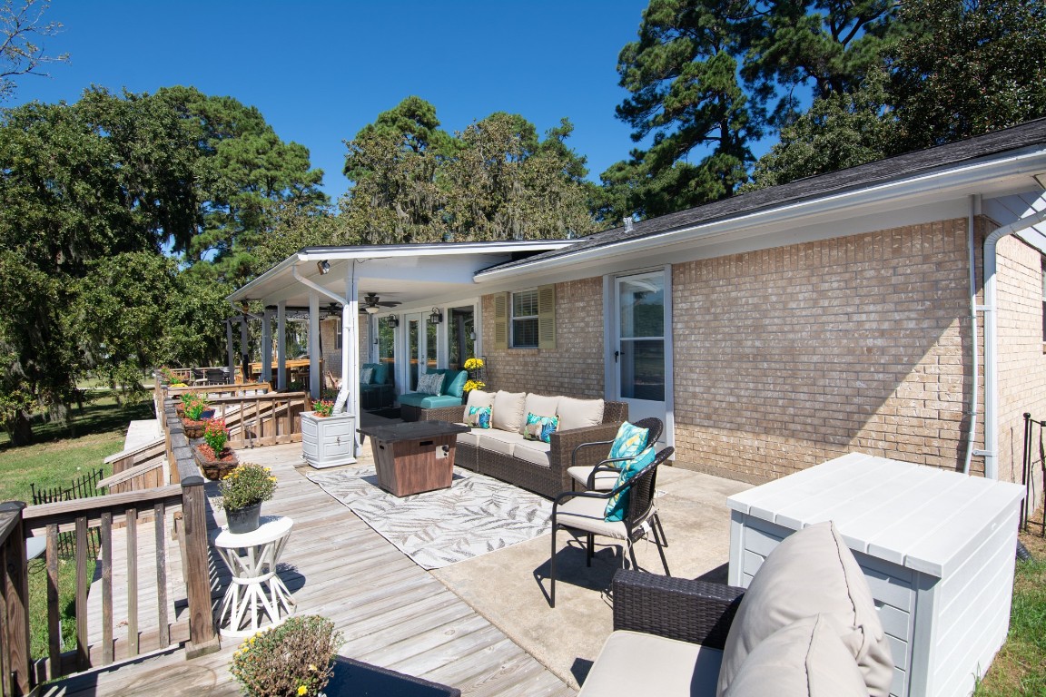 150 Edgewater Way Point Blank, TX 77364 - Photo 24 of 48 a view of a patio with couches table and chairs potted plants and large tree