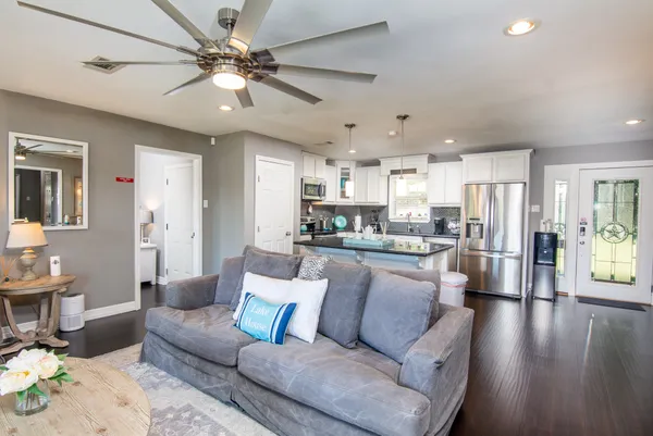 a living room with furniture and kitchen view