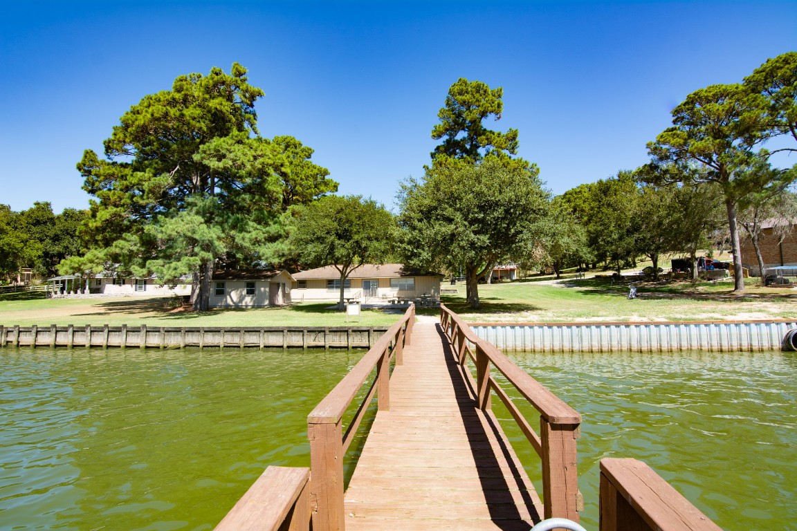 150 Edgewater Way Point Blank, TX 77364 - Photo 42 of 48 a view of a swimming pool with a bench in a patio