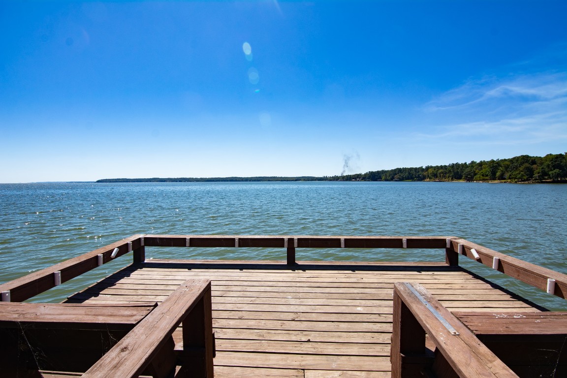 150 Edgewater Way Point Blank, TX 77364 - Photo 46 of 48 a view of a roof deck with wooden floor and city view