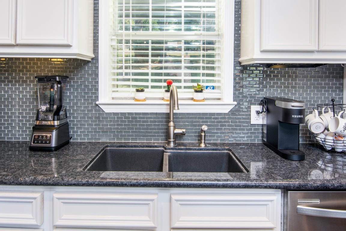 150 Edgewater Way Point Blank, TX 77364 - Photo 7 of 48 a kitchen with kitchen island a sink a counter space and cabinets