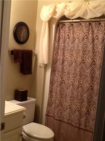 4111 Meadow View Circle Pleasant View, TN 37146 - Photo 14 of 16 a bathroom with a toilet and a shower curtain