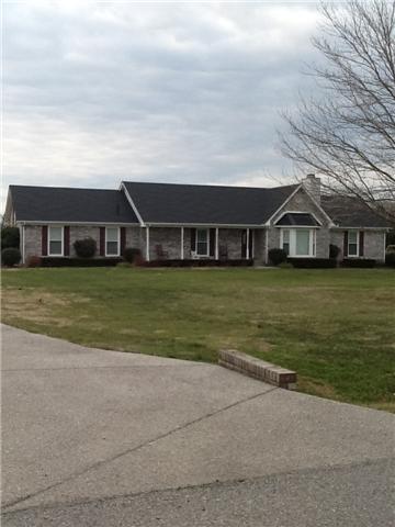 4111 Meadow View Circle Pleasant View, TN 37146 - Photo 2 of 16 a view of a building with a big yard and large trees