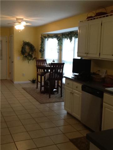 4111 Meadow View Circle Pleasant View, TN 37146 - Photo 7 of 16 a kitchen with stainless steel appliances granite countertop a sink counter space and a window