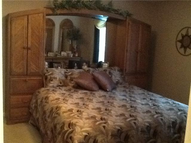 4111 Meadow View Circle Pleasant View, TN 37146 - Photo 9 of 16 a bedroom with a bed and a mirror