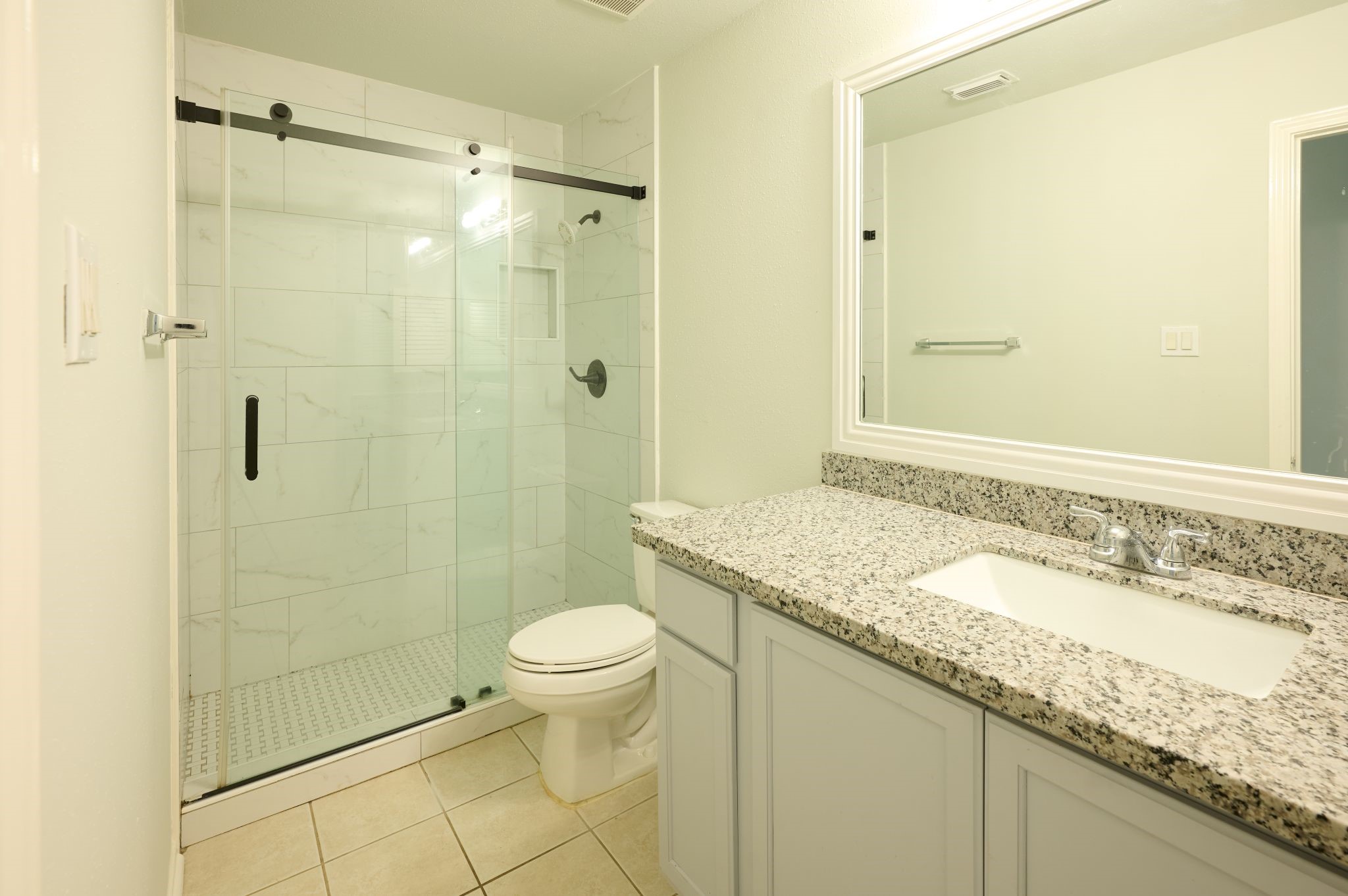 5838 North Magazine Circle Houston, TX 77084 - Photo 16 of 30 a bathroom with a granite countertop sink a toilet and shower