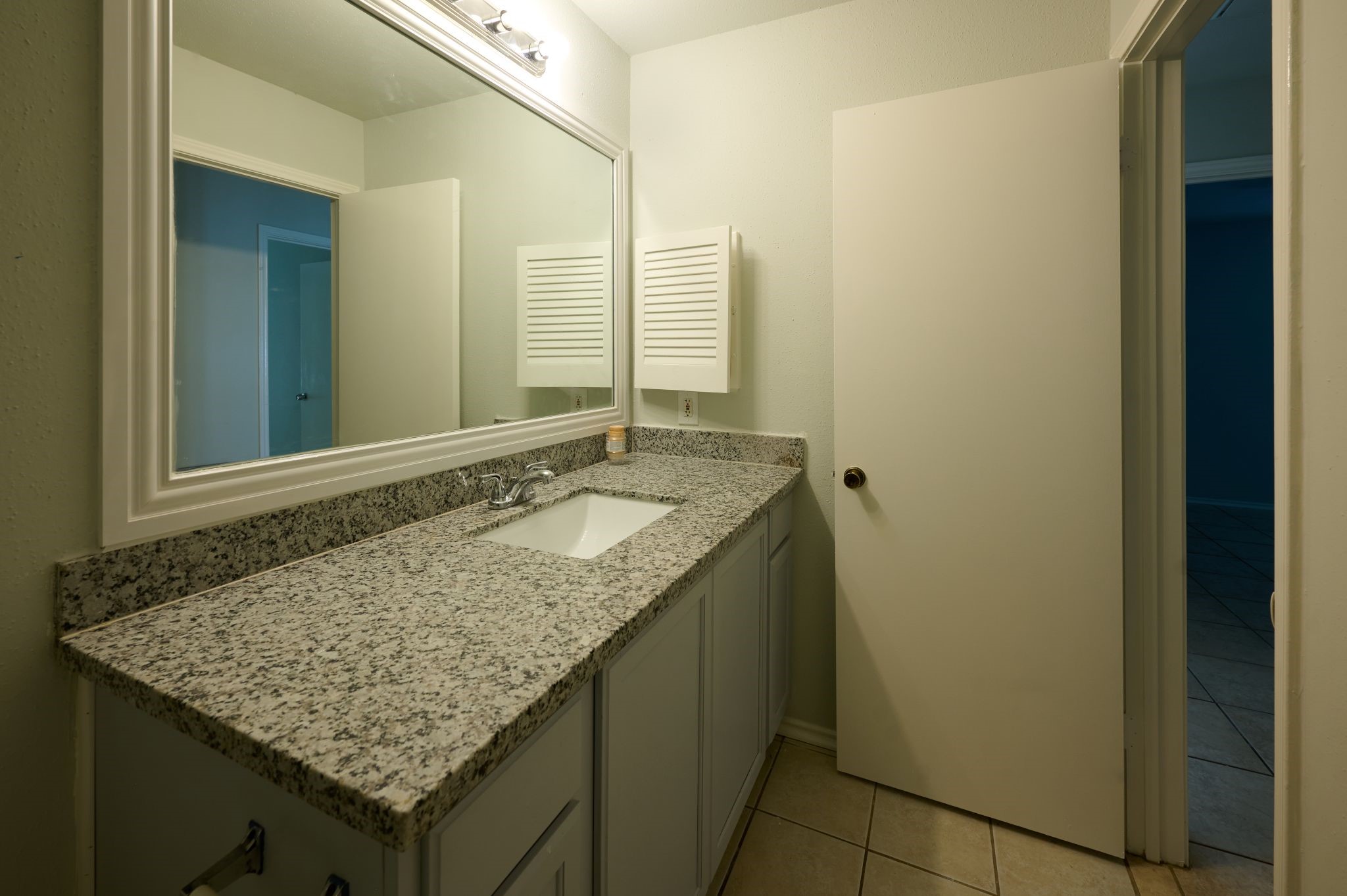5838 North Magazine Circle Houston, TX 77084 - Photo 17 of 30 a bathroom with a granite countertop sink and a mirror