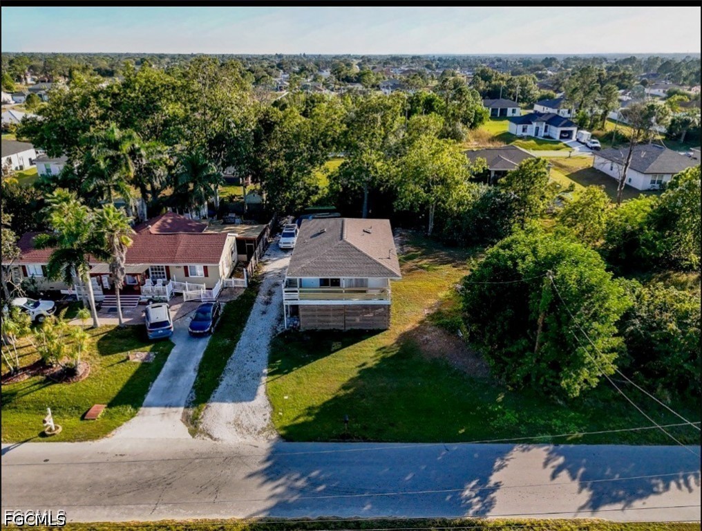3909 3rd Street Southwest Lehigh Acres, FL 33976 - Photo 2 of 2 an aerial view of a house with a yard basket ball court and outdoor seating