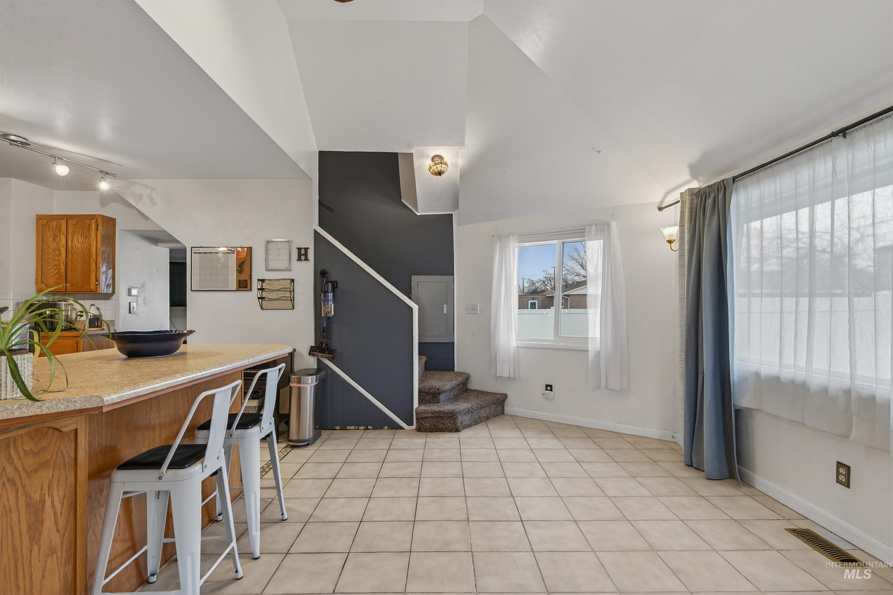1266 Poplar Street Clarkston, WA 99403 - Photo 13 of 31 Kitchen with light countertops, a breakfast bar area, lofted ceiling, and wood finish cabinets