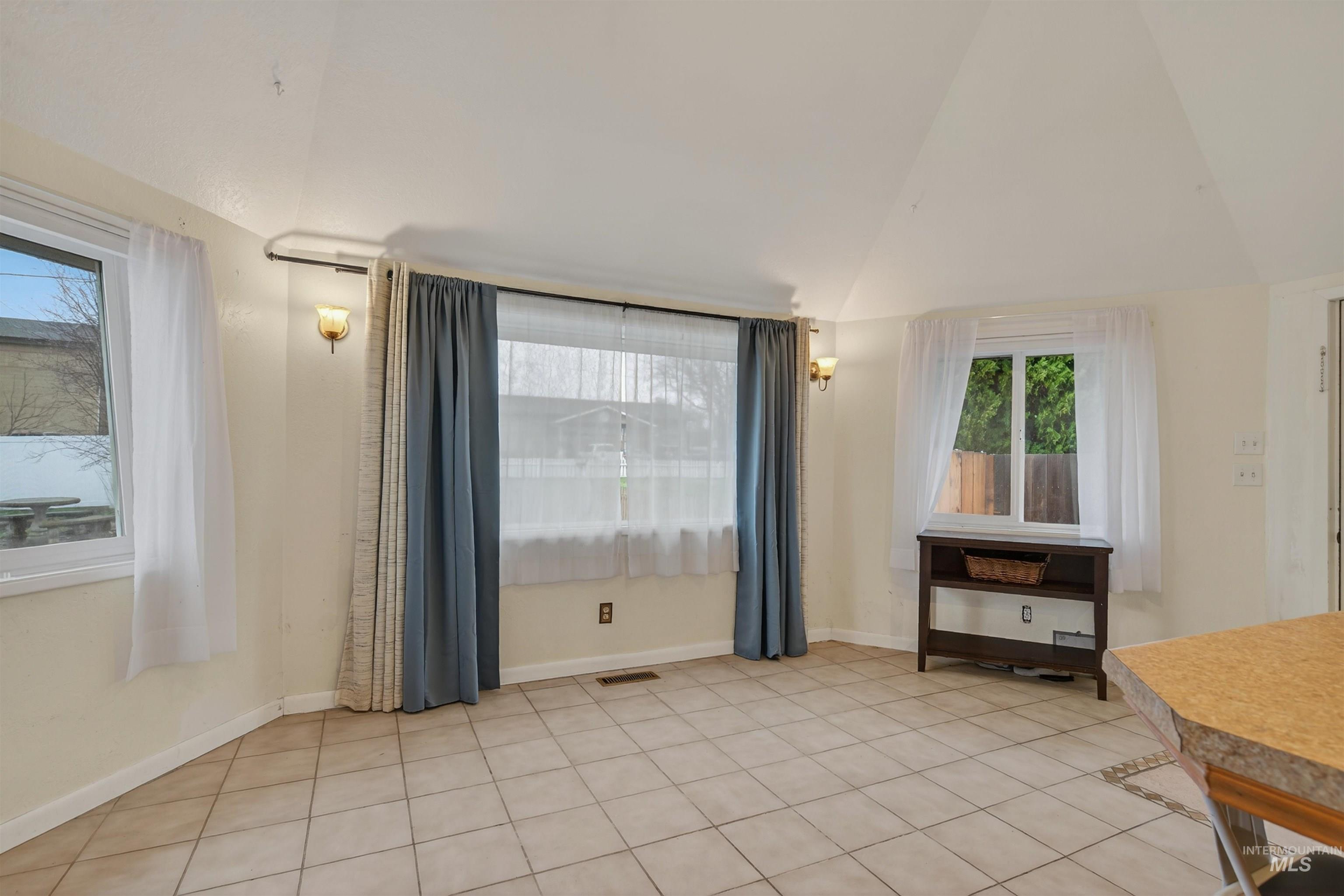 1266 Poplar Street Clarkston, WA 99403 - Photo 14 of 31 Dining space featuring lofted ceiling and light tile patterned flooring