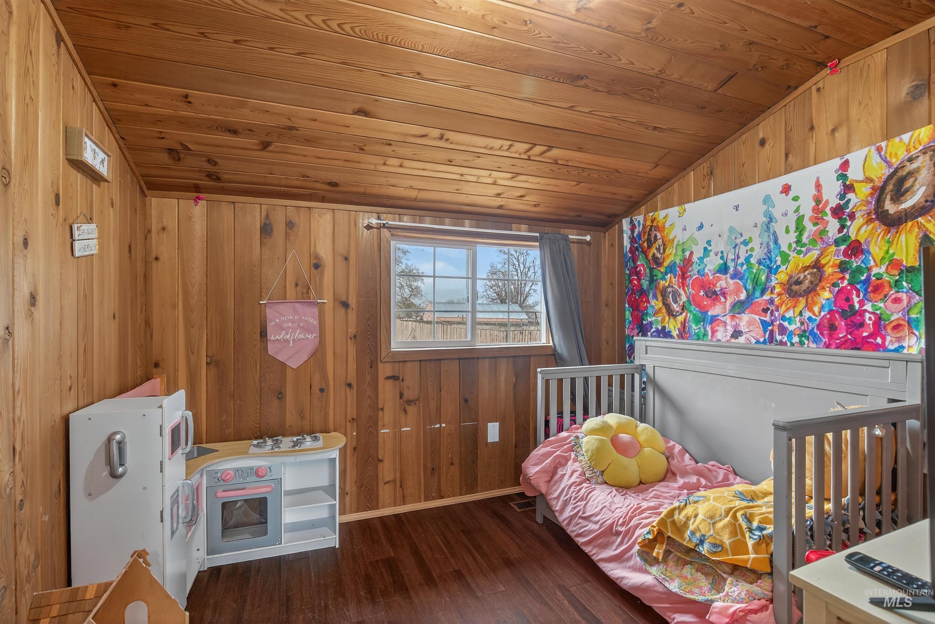 1266 Poplar Street Clarkston, WA 99403 - Photo 15 of 31 Bedroom with wooden walls, a vaulted wooden ceiling, and dark wood finished floors