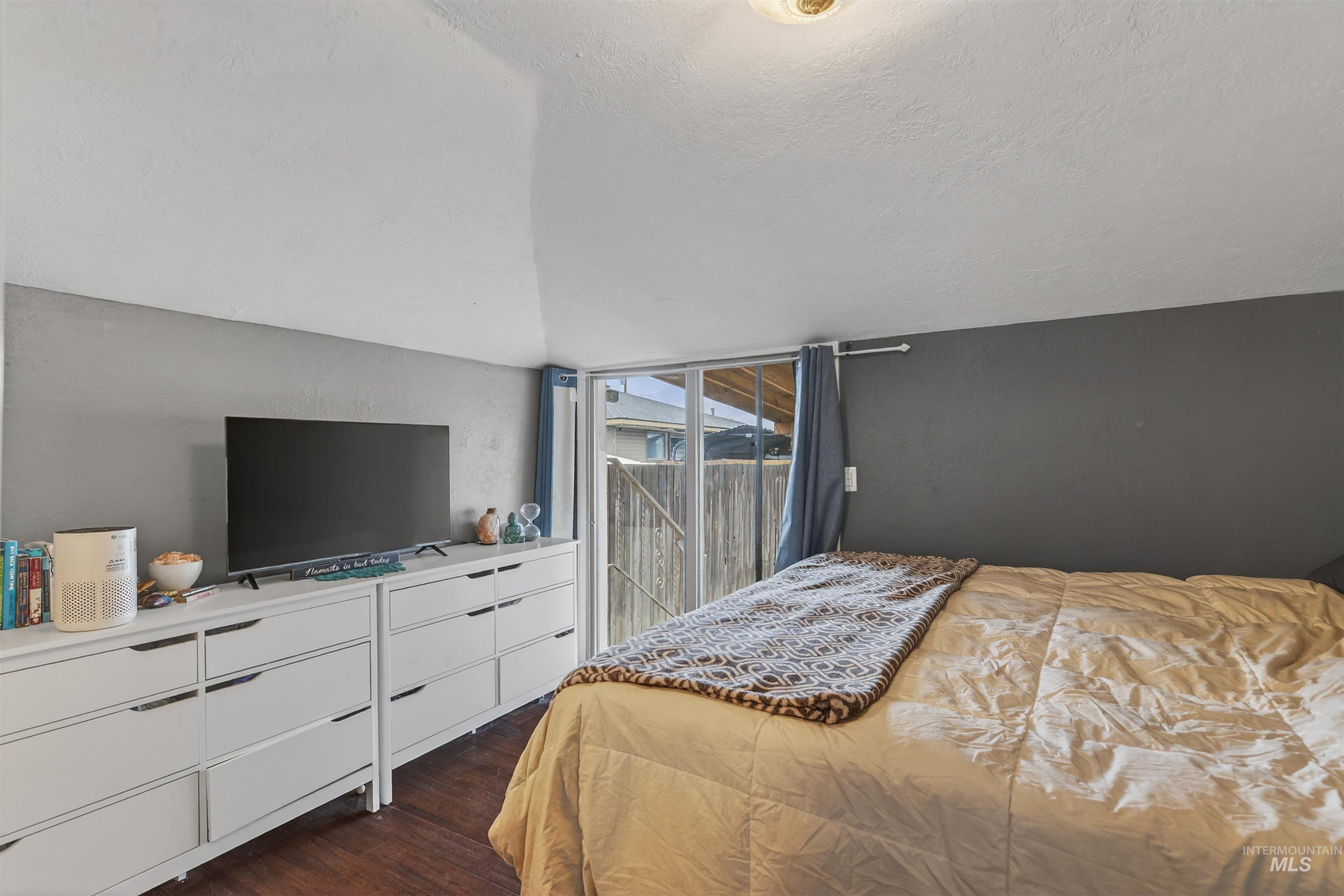 1266 Poplar Street Clarkston, WA 99403 - Photo 16 of 31 Bedroom with access to outside and dark wood-style flooring