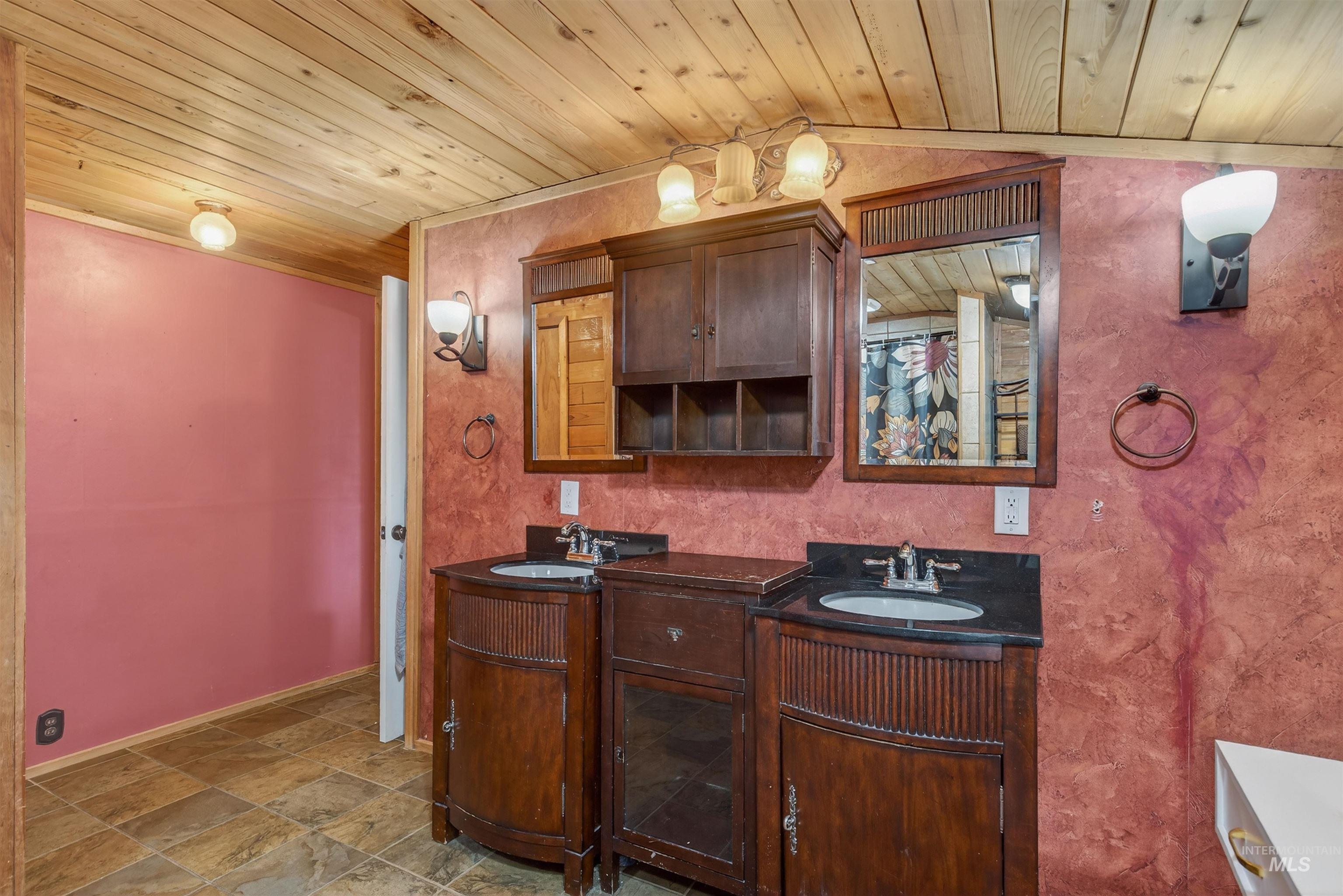 1266 Poplar Street Clarkston, WA 99403 - Photo 17 of 31 Full bathroom with double vanity, a vaulted wooden ceiling, and light stone finish floors