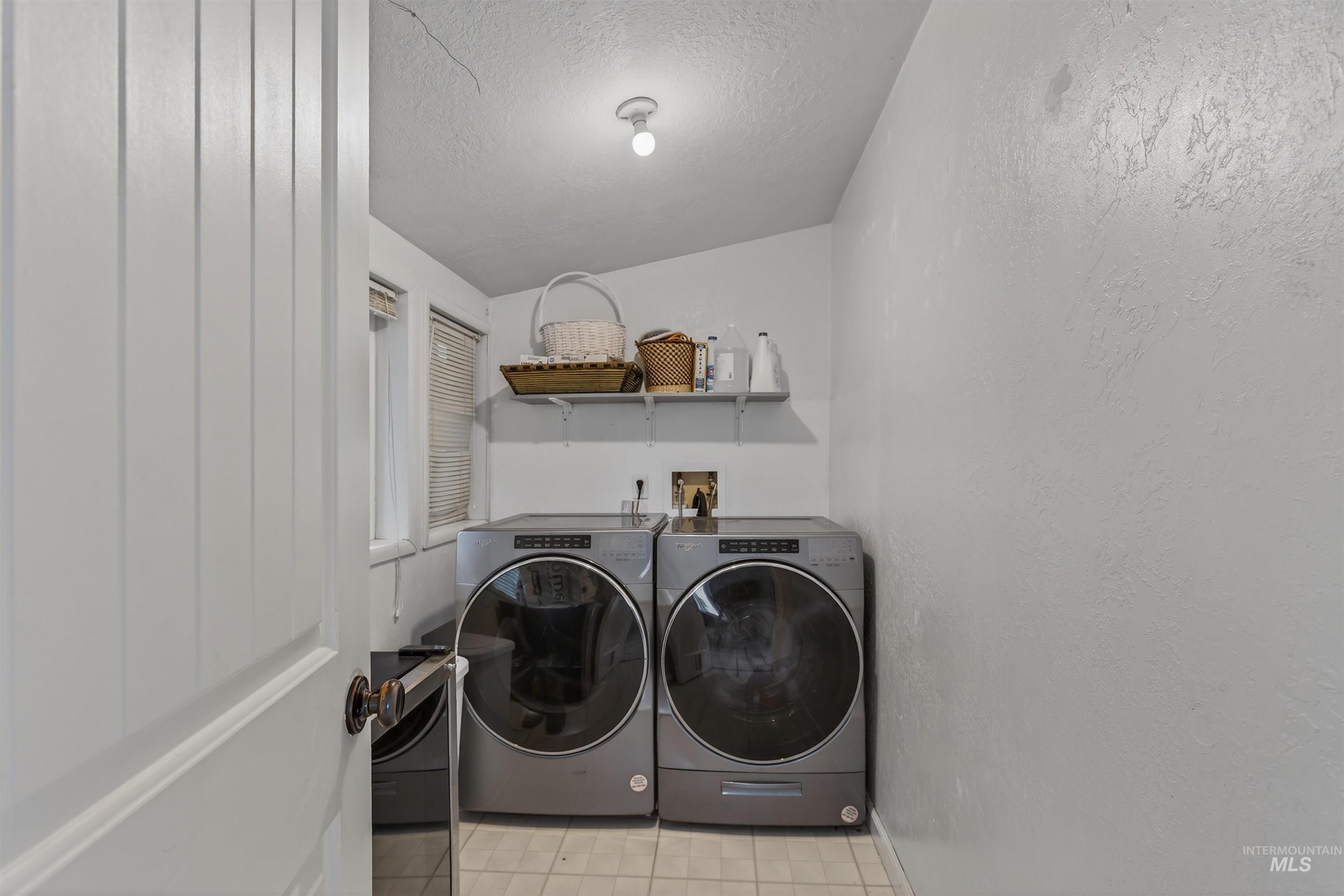 1266 Poplar Street Clarkston, WA 99403 - Photo 20 of 31 Laundry room featuring a textured ceiling, washer and dryer, and a textured wall