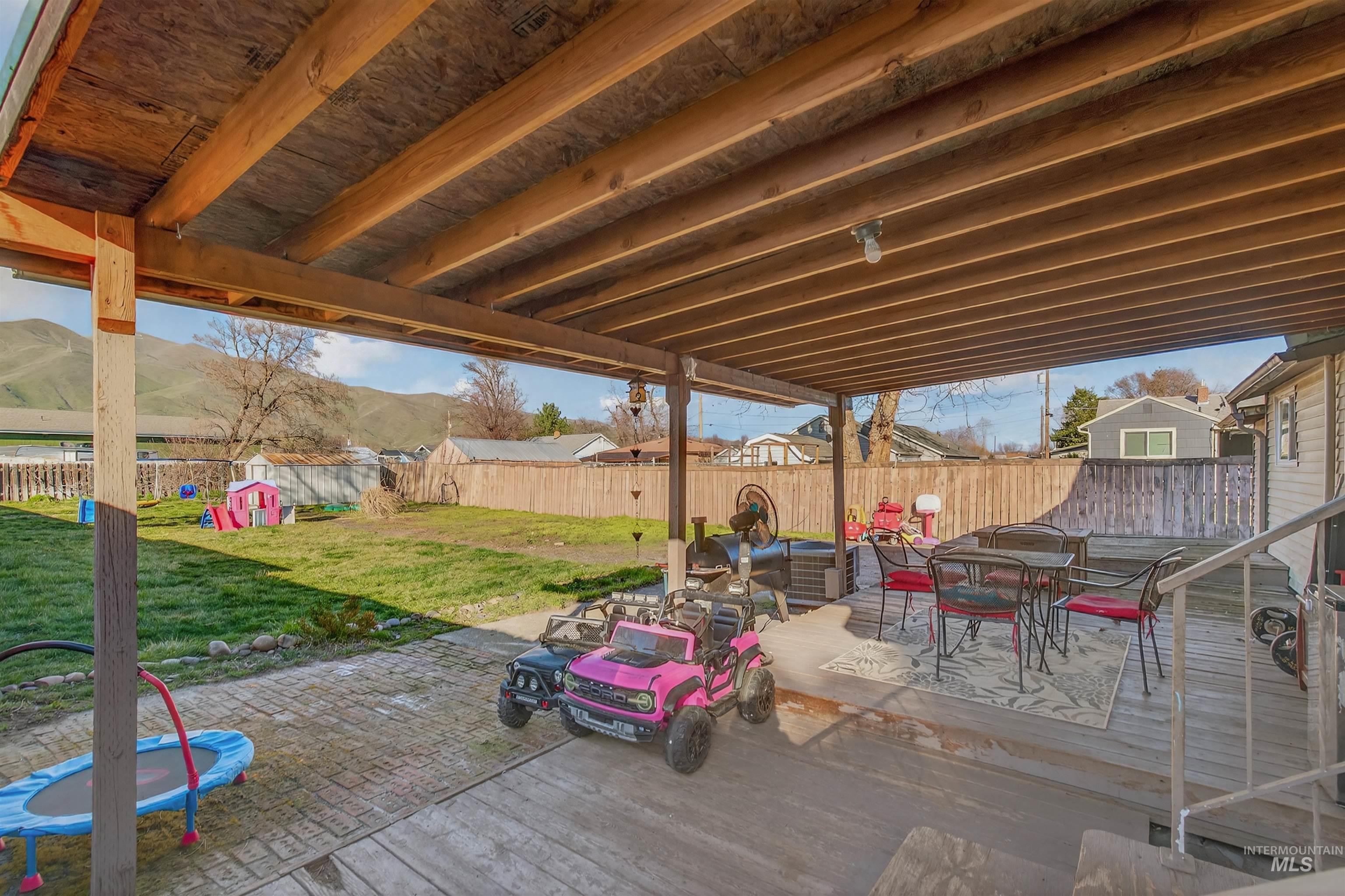 1266 Poplar Street Clarkston, WA 99403 - Photo 29 of 31 Fenced backyard with outdoor dining area, a patio, and a wooden deck