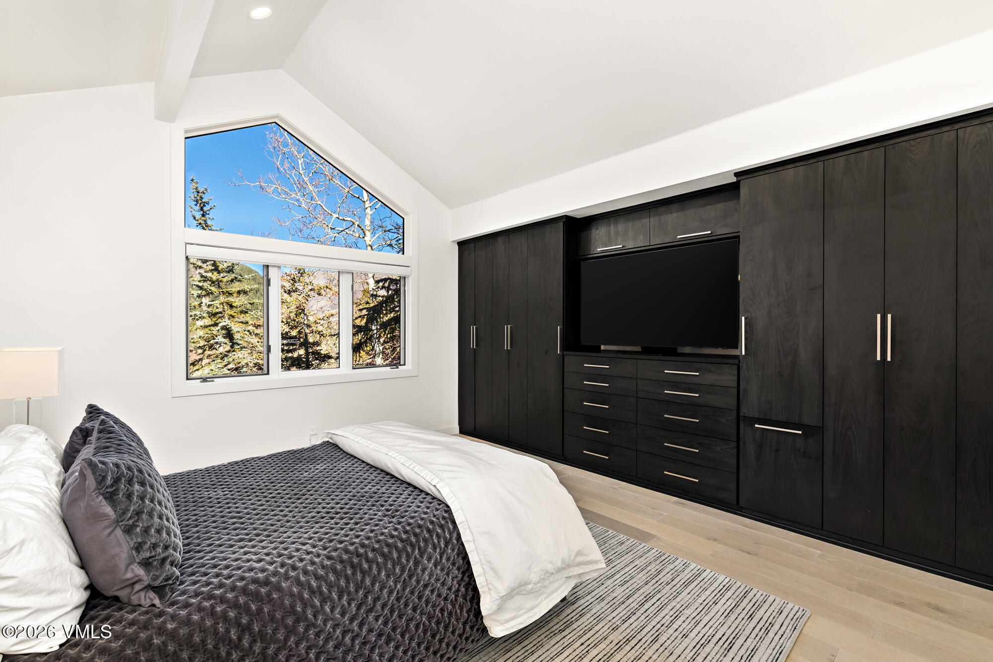 4515 Big Horn Road, Unit F Vail, CO 81657 - Photo 15 of 35 a bedroom with a bed and a television