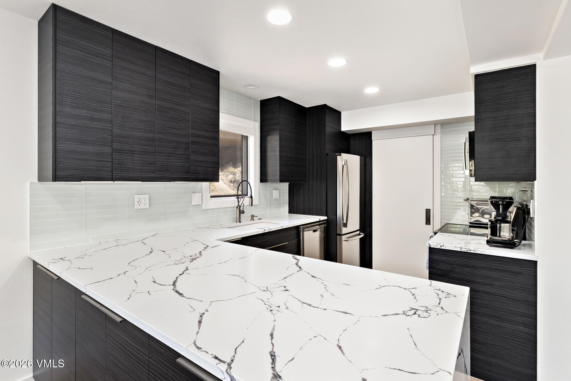 4515 Big Horn Road, Unit F Vail, CO 81657 - Photo 9 of 35 a kitchen with a sink a refrigerator and cabinets