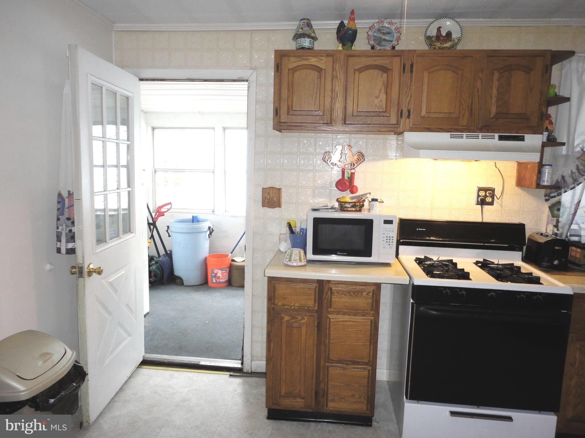 8201 Bullneck Road Baltimore, MD 21222 - Photo 13 of 33 Sunroom leads to kitchen