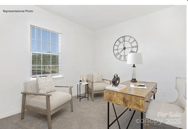 a living room with furniture a window and a table
