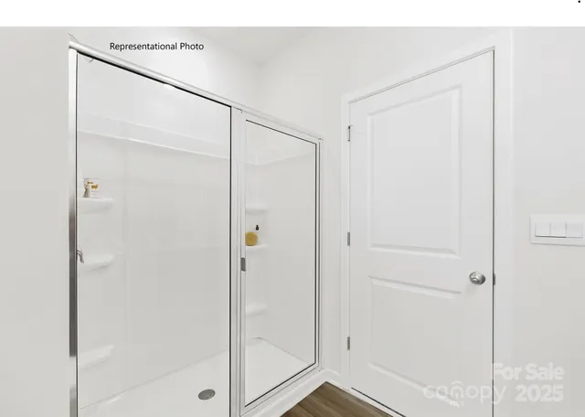 a bathroom with a glass shower door