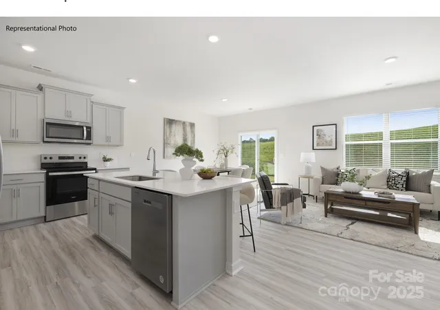 a kitchen with sink a microwave and cabinets
