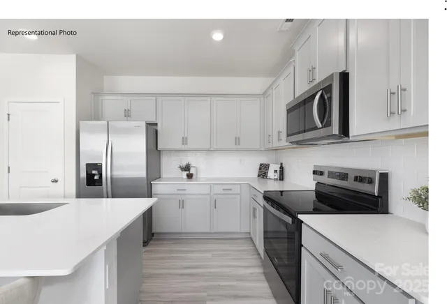 a kitchen with a sink a stove and refrigerator