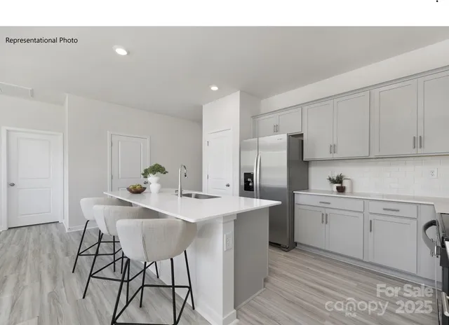 a kitchen with a sink cabinets and wooden floor