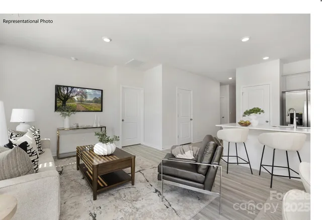 a living room with furniture a rug and a painting on the wall