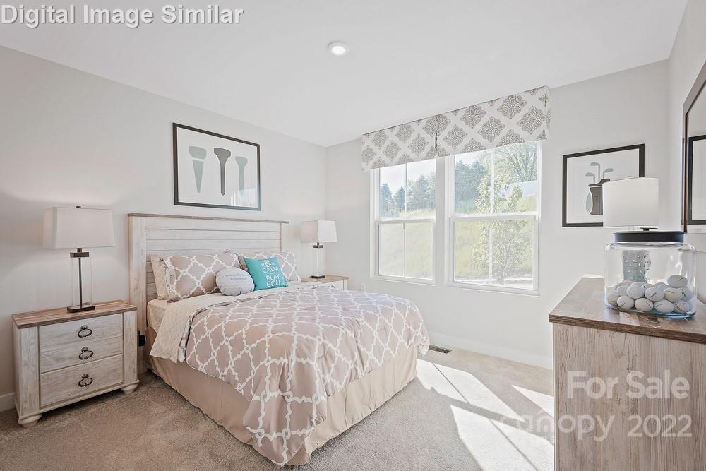 325 Damask Drive, Unit 118 Lancaster, SC 29720 - Photo 10 of 12 a bedroom with a bed and a window