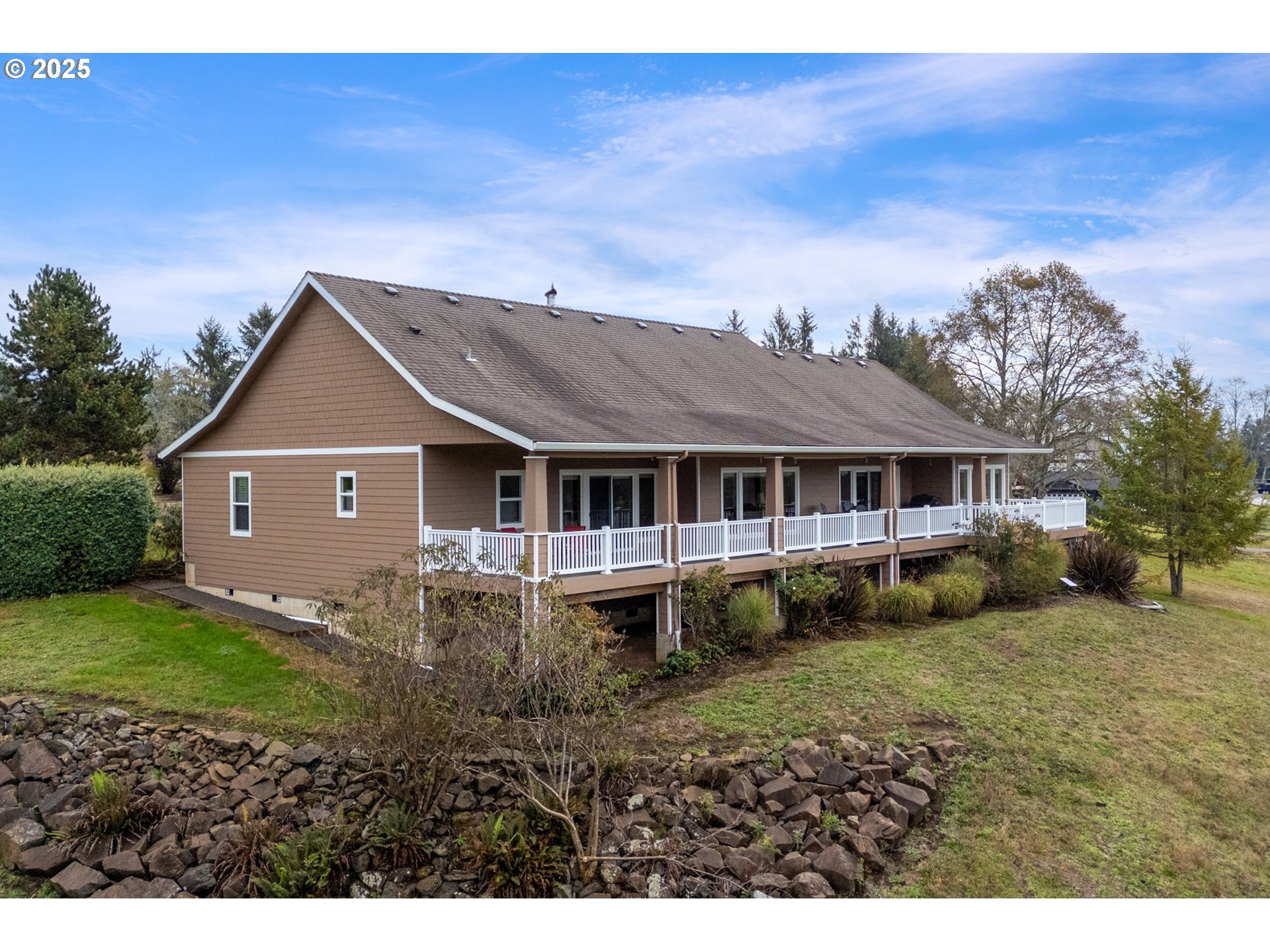 9500 Walz Hill Road Tillamook, OR 97141 - Photo 2 of 47 a aerial view of a house next to a big yard and large trees
